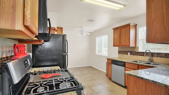 kitchen with sink, light tile patterned floors, decorative backsplash, dishwasher, and ceiling fan