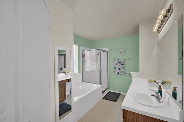 bathroom with plus walk in shower, vanity, and tile patterned floors