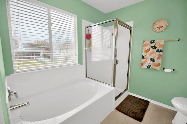 bathroom featuring tile patterned floors, plus walk in shower, and toilet