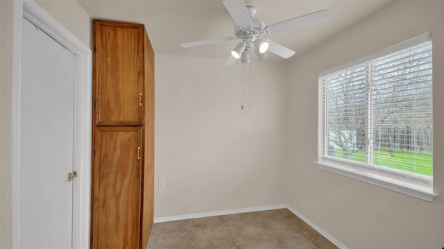 unfurnished room with ceiling fan and light tile patterned floors