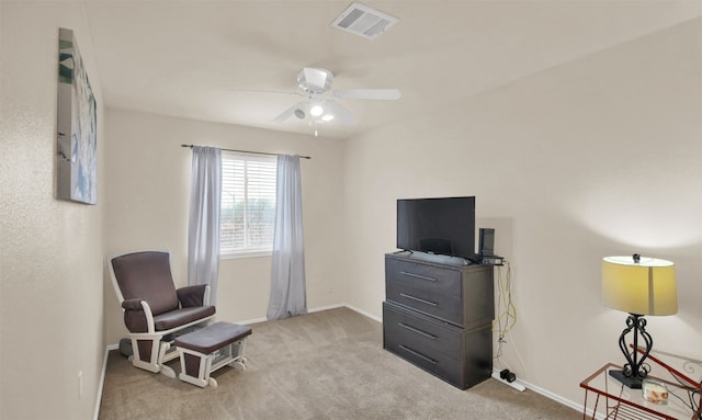 sitting room featuring light carpet and ceiling fan