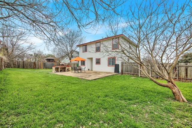 back of house featuring a patio and a lawn