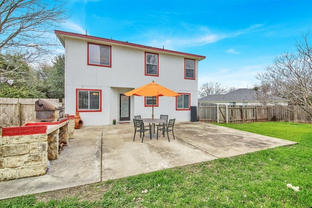 back of property featuring a patio, a yard, and area for grilling