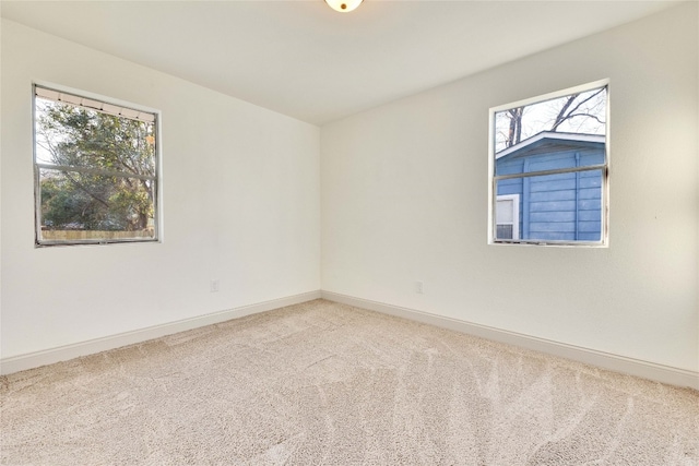 unfurnished room featuring a healthy amount of sunlight and carpet flooring