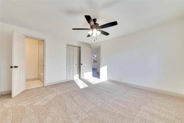 unfurnished bedroom with ceiling fan and light colored carpet