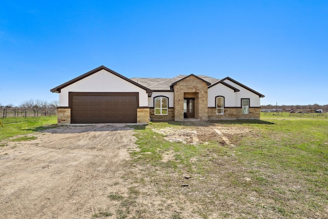 view of front of home featuring a front lawn and a garage