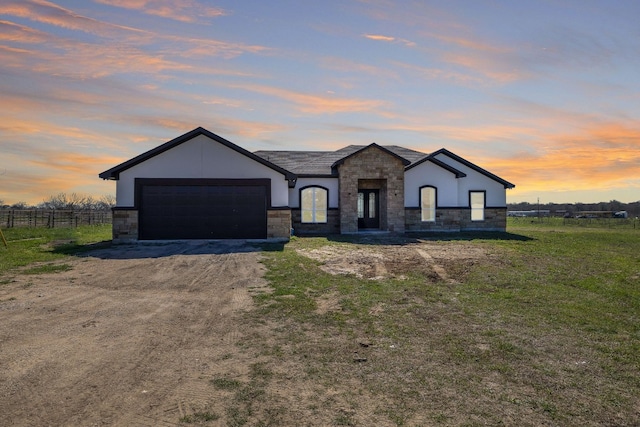 view of front of house with a yard and a garage