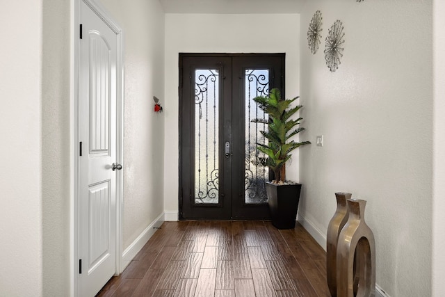 foyer entrance with dark hardwood / wood-style floors and french doors