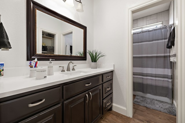 bathroom with hardwood / wood-style flooring and oversized vanity