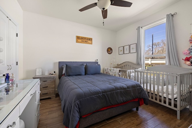 bedroom featuring ceiling fan and dark wood-type flooring