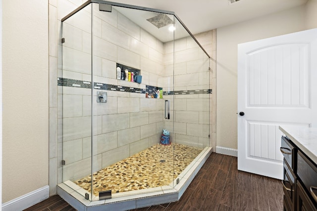 bathroom featuring hardwood / wood-style floors and an enclosed shower