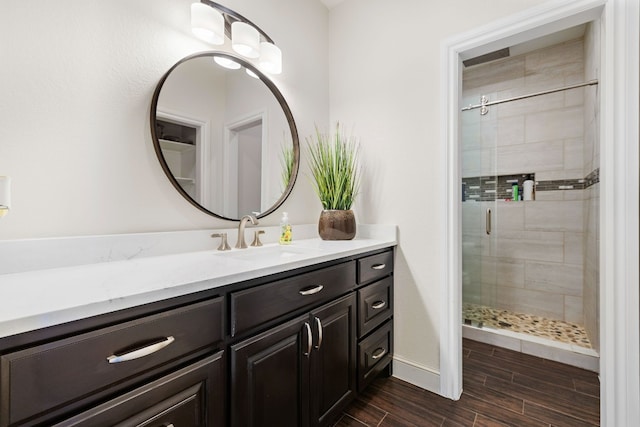 bathroom featuring walk in shower and vanity