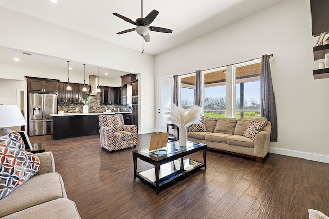 living room with ceiling fan and dark hardwood / wood-style flooring