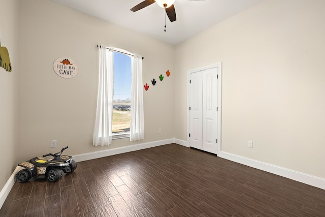 spare room with ceiling fan and dark wood-type flooring