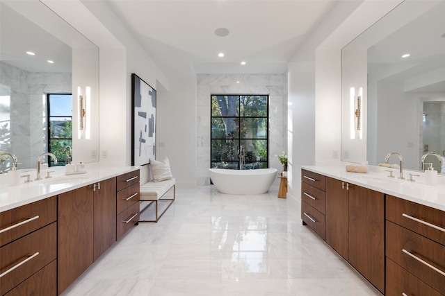 bathroom featuring a bathing tub, plenty of natural light, and vanity