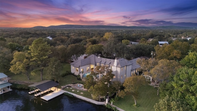 aerial view at dusk with a water view