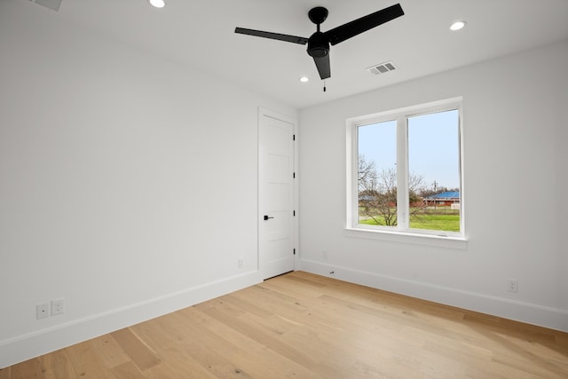 unfurnished room with ceiling fan and light wood-type flooring