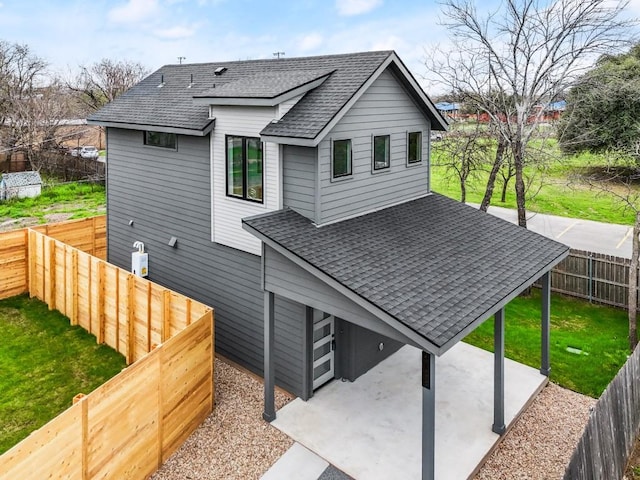 rear view of house with a yard