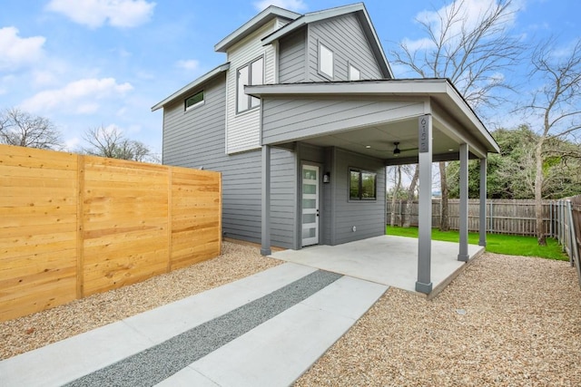 view of front of home featuring ceiling fan and a patio area