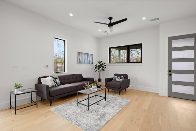 living room with ceiling fan and light wood-type flooring