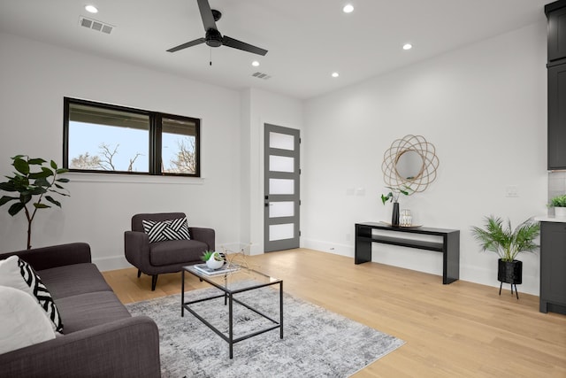 living room featuring ceiling fan and light hardwood / wood-style floors