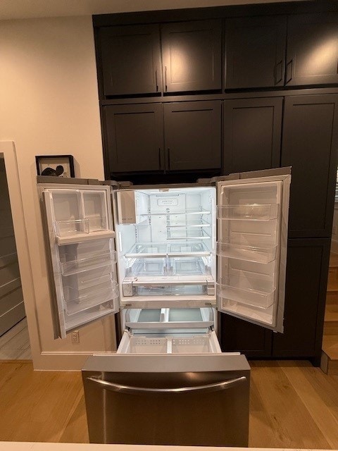 details with refrigerator and light wood-type flooring