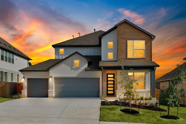 view of front of home with a lawn and a garage