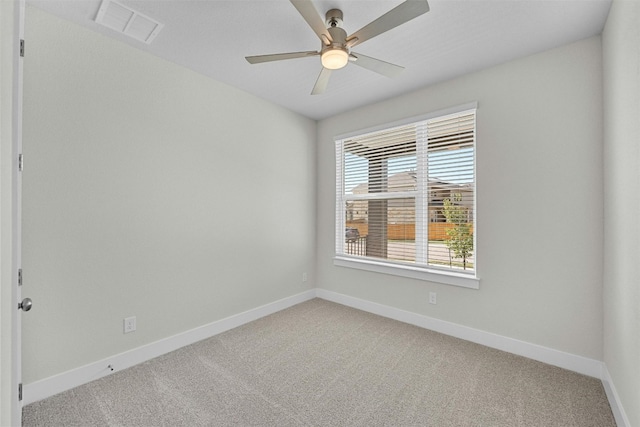 carpeted spare room featuring ceiling fan