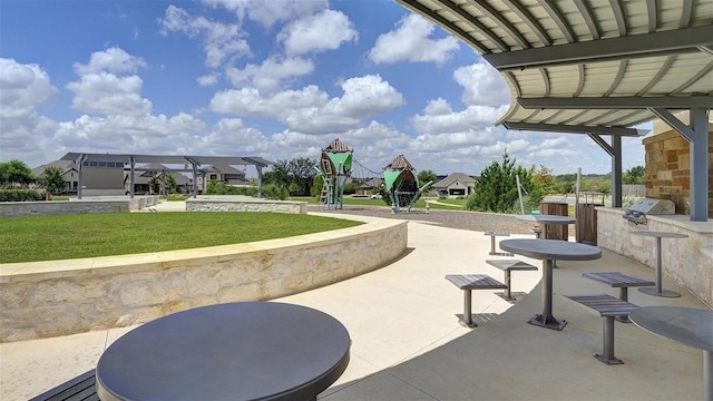 surrounding community with a lawn and an outdoor kitchen