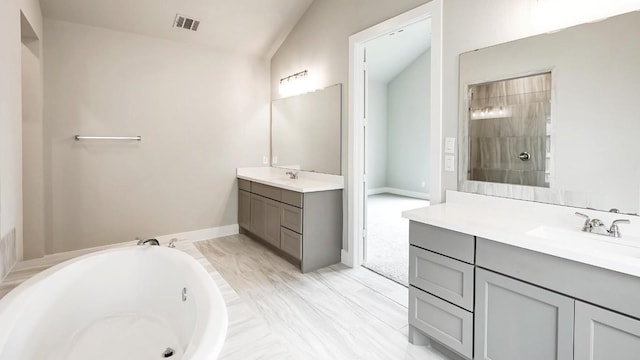 bathroom with plus walk in shower, vanity, and vaulted ceiling