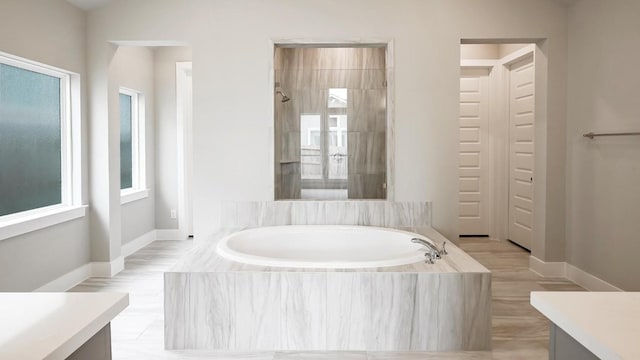 bathroom featuring plus walk in shower and vanity