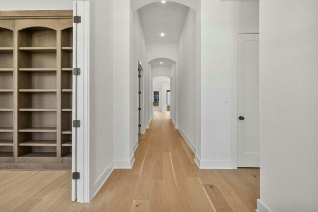 corridor with light hardwood / wood-style floors