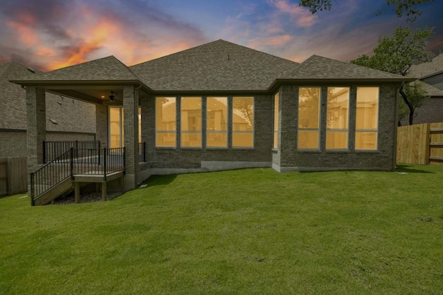 back house at dusk with a yard