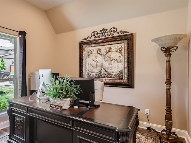 office with baseboards, vaulted ceiling, and wood finished floors