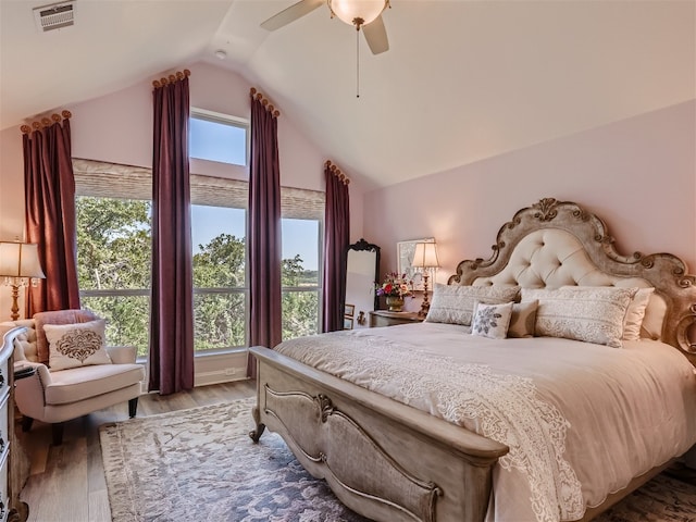 bedroom featuring vaulted ceiling, visible vents, ceiling fan, and wood finished floors