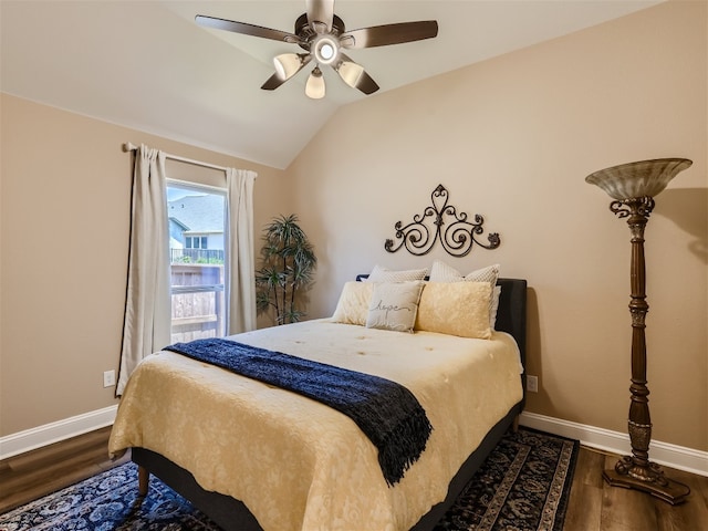 bedroom featuring ceiling fan, baseboards, dark wood-style floors, and vaulted ceiling