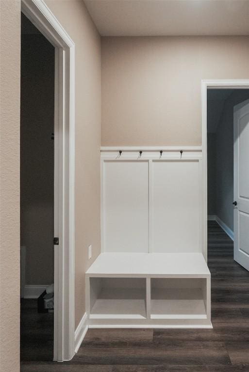 mudroom with dark wood-type flooring and baseboards