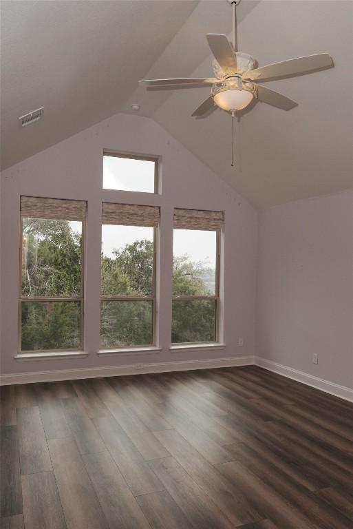 bonus room featuring vaulted ceiling, dark wood-type flooring, visible vents, and baseboards