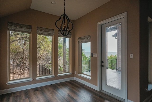 doorway to outside featuring a chandelier, baseboards, dark wood-style floors, and lofted ceiling