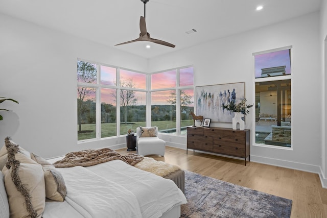 bedroom with ceiling fan and light hardwood / wood-style flooring