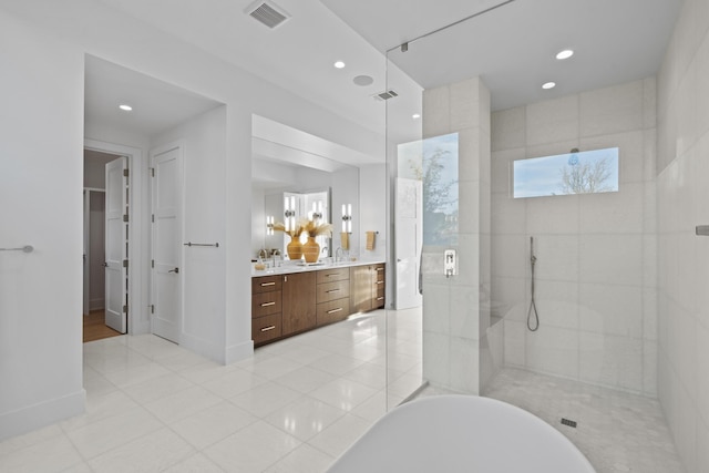 bathroom with tile patterned floors, vanity, and shower with separate bathtub