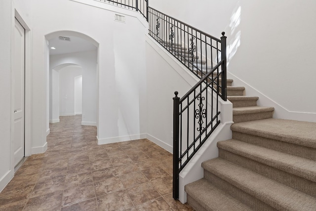 staircase featuring tile patterned flooring