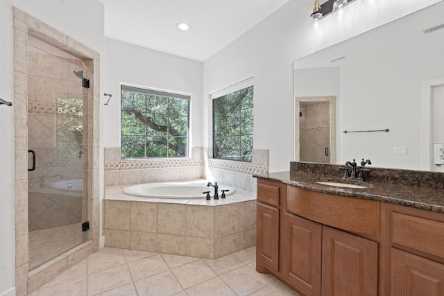 bathroom featuring separate shower and tub, vanity, and tile patterned floors