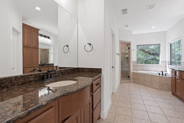 bathroom featuring tile patterned flooring, vanity, and shower with separate bathtub