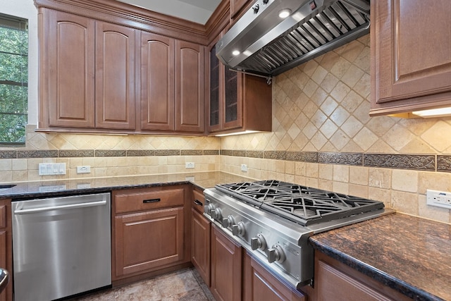 kitchen featuring light tile patterned flooring, backsplash, stainless steel appliances, and custom range hood