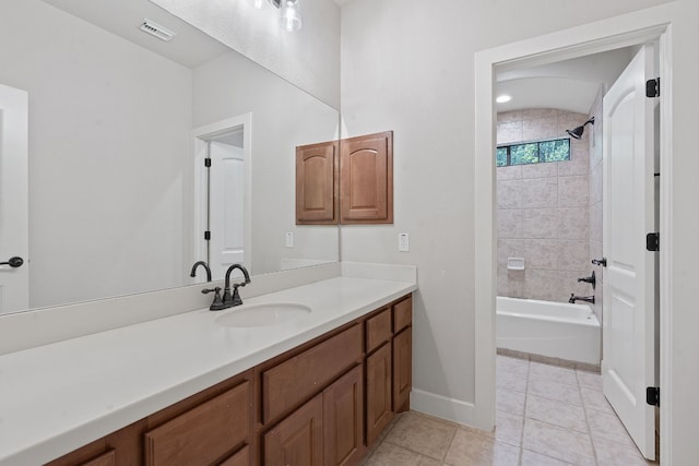 bathroom featuring tile patterned floors, vanity, and tiled shower / bath combo