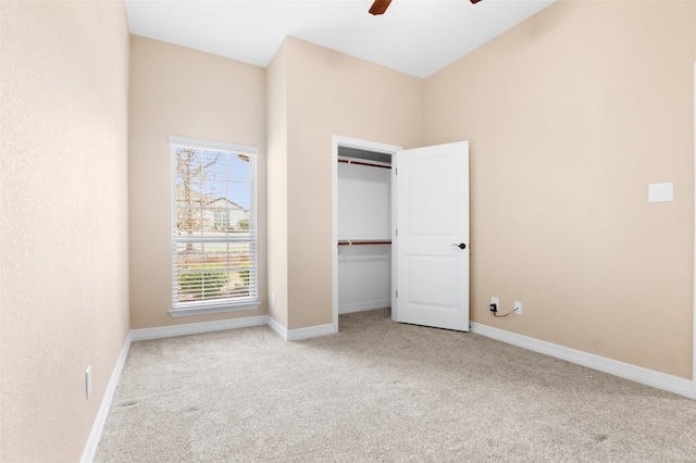 unfurnished bedroom with a closet, light carpet, and ceiling fan