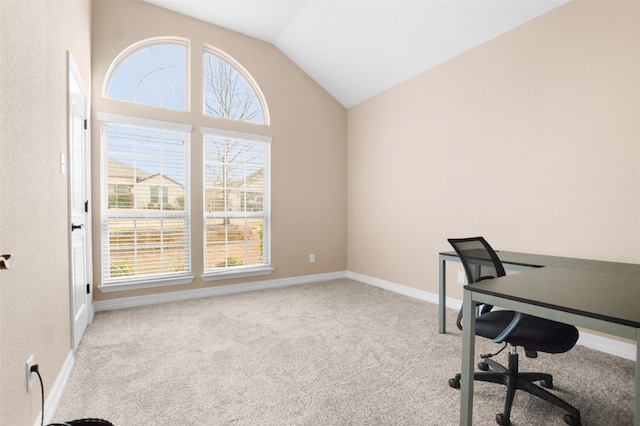 carpeted office space featuring lofted ceiling