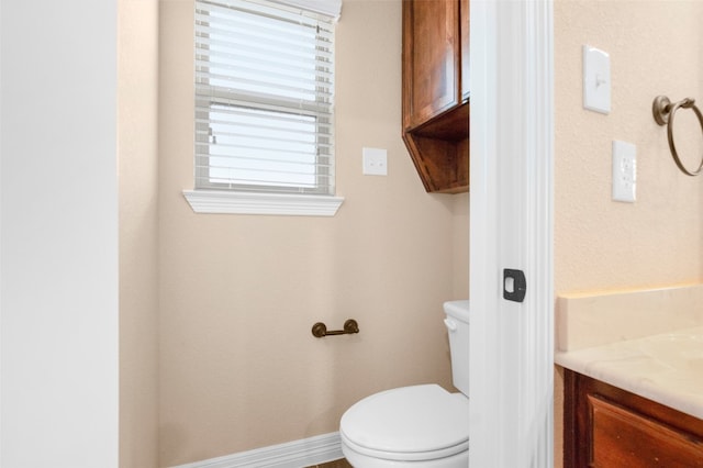 bathroom featuring toilet and vanity