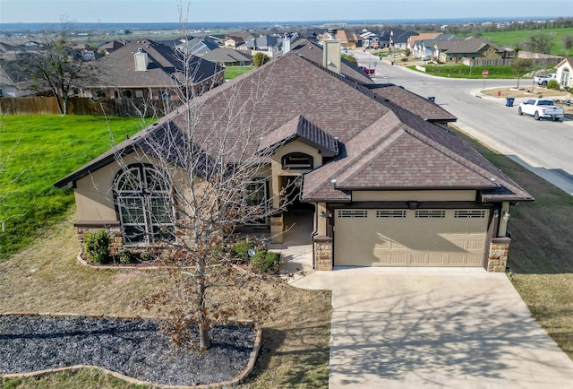 view of front of home featuring a front lawn and a garage